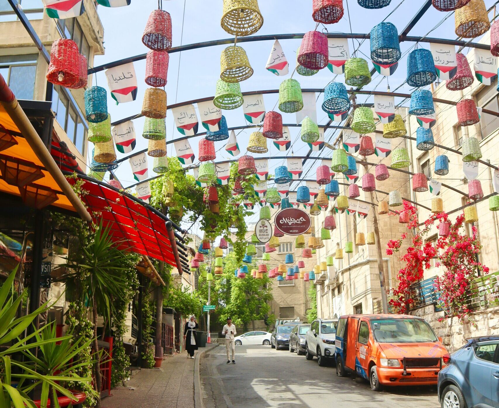 a city street lined with lots of colorful paper lanterns
